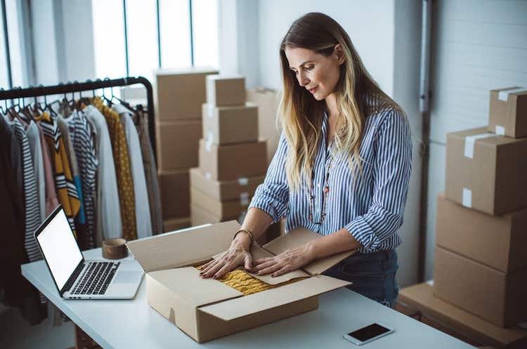Woman boxing up a sweater
