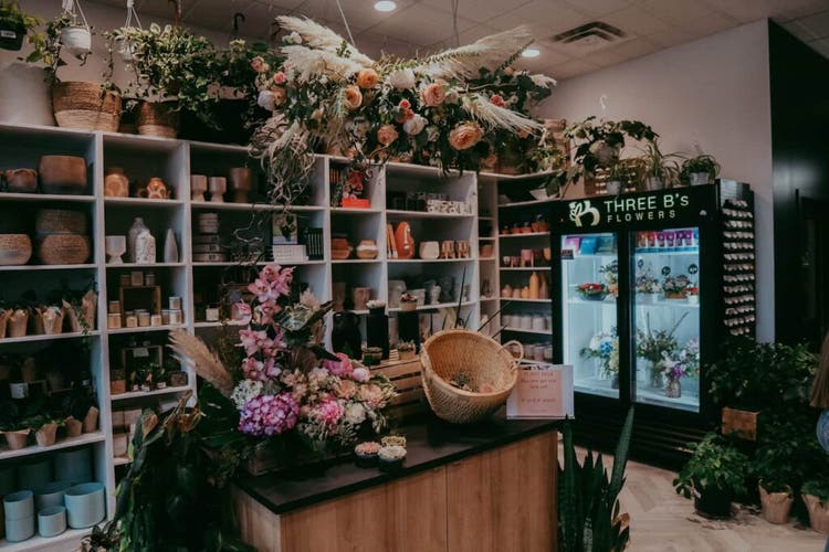 Flower arrangement and pottery on shelves