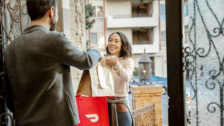 Woman making DoorDash delivery