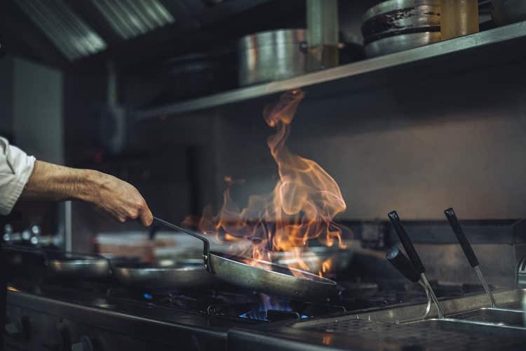 Chef cooking on commercial stove
