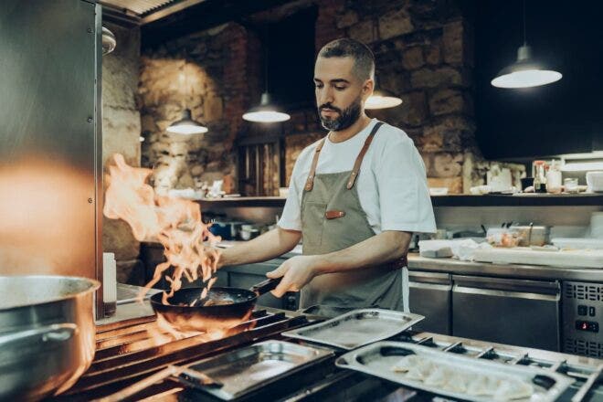 Chef cooking over stove