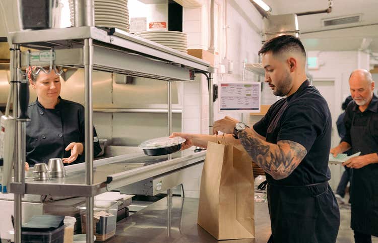 restaurant employee preparing online order in kitchen