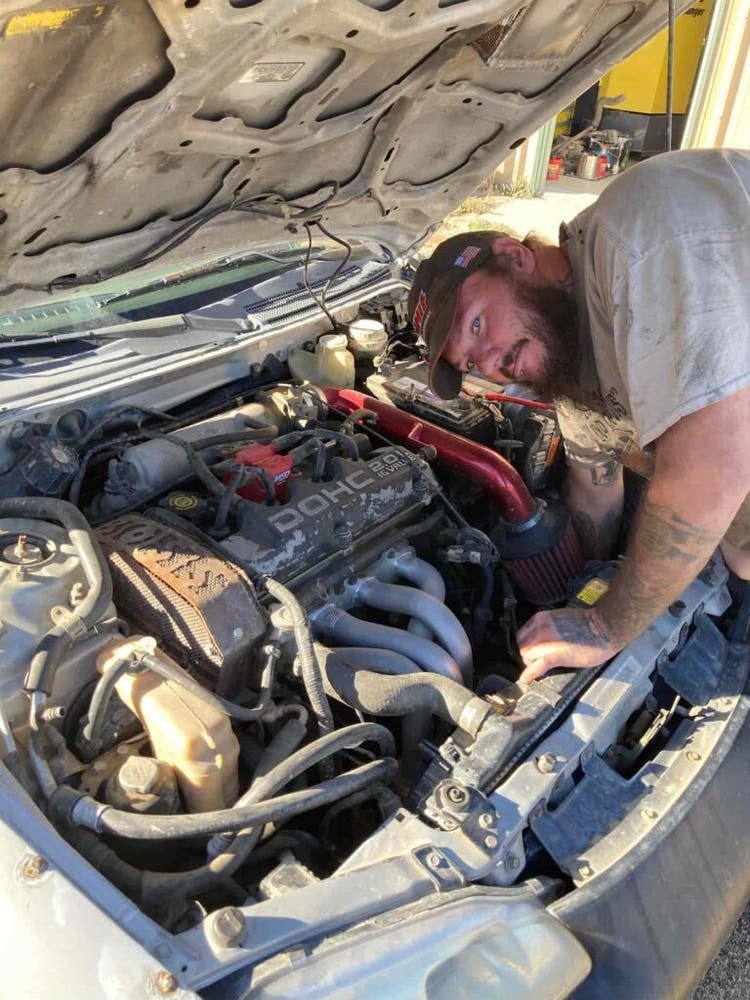 Owner of Boss Custom working on a car