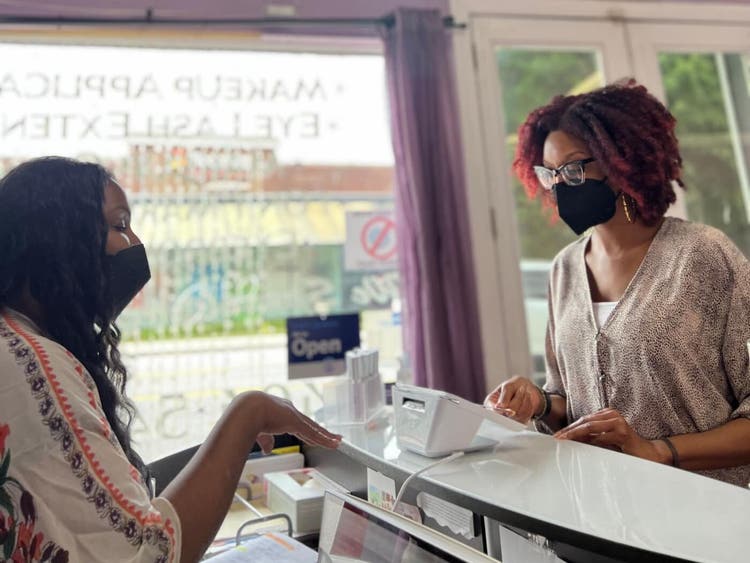 Blushbaby owner with a customer at her Clover POS system