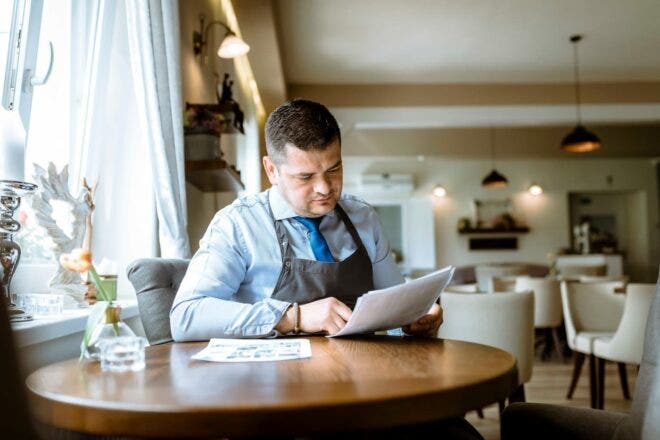 Restaurant manager looking at papers