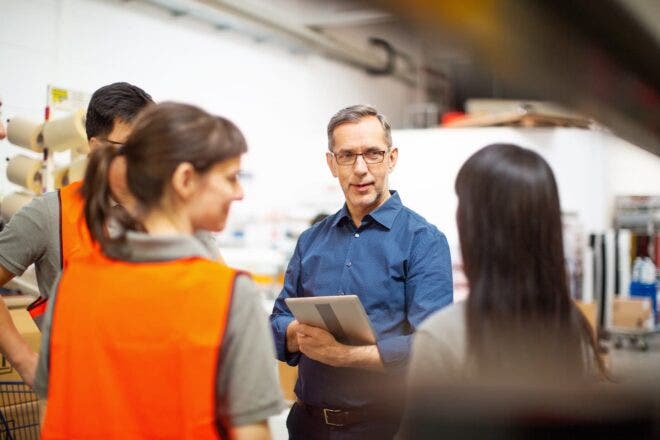Manager talking with factory workers