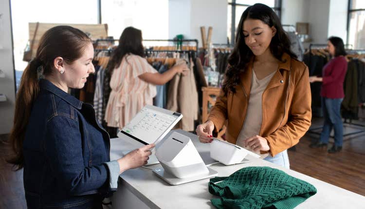 Cashier and customer at checkout counter