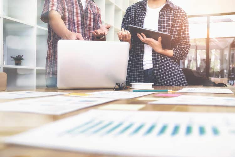 Two people looking at sales data