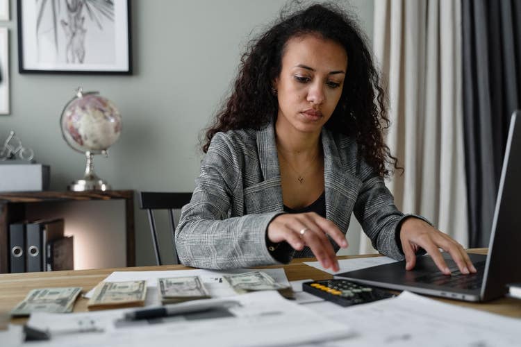 Woman in blazer working on finances