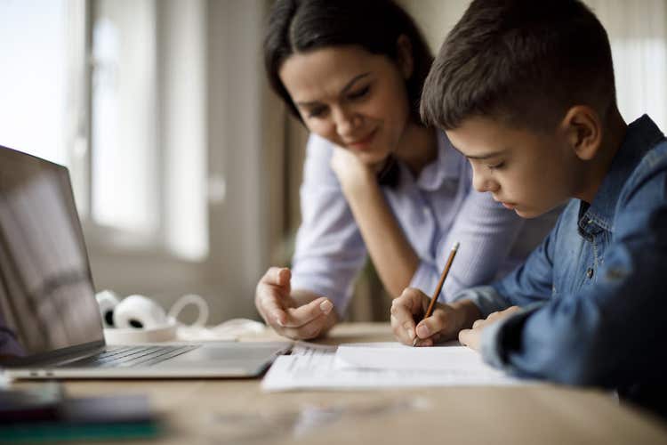 Woman tutoring boy
