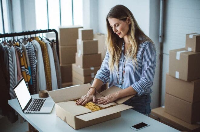 Woman boxing up a sweater