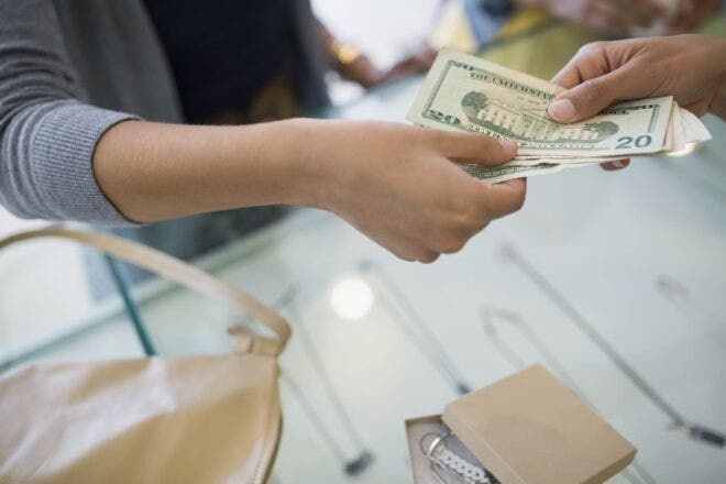 Person paying cash for jewelry