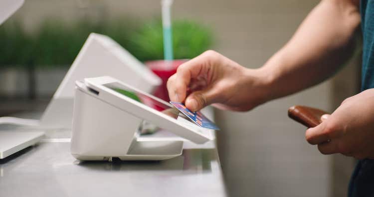 Customer using gift card to pay at cafe