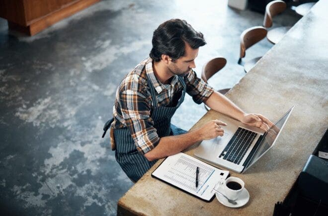 Restaurant owner working on laptop