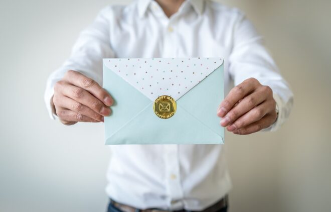 Man holding sealed envelope