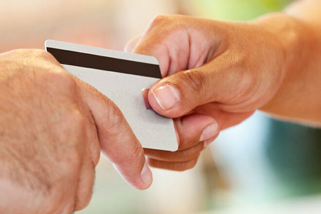 Hands exchanging credit card