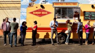 People standing in front of food truck