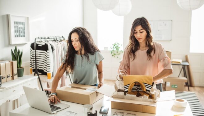 Two women packing online orders