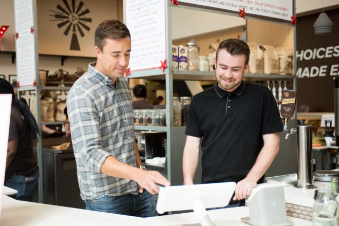 Two employees looking at Clover POS