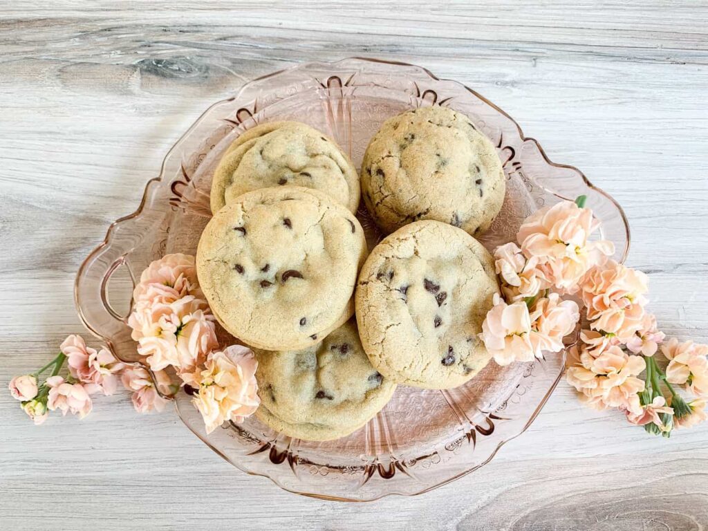 Chocolate Chip cookies on a plate surrounded by flowers