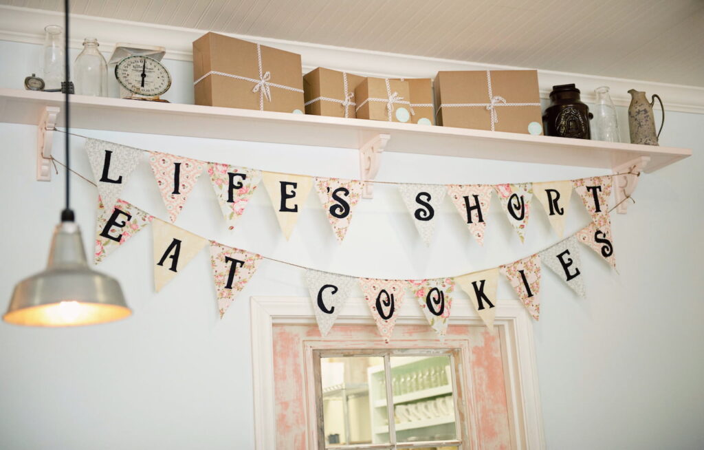 Interior of Milk Jar Cookies with banner life's short eat cookies