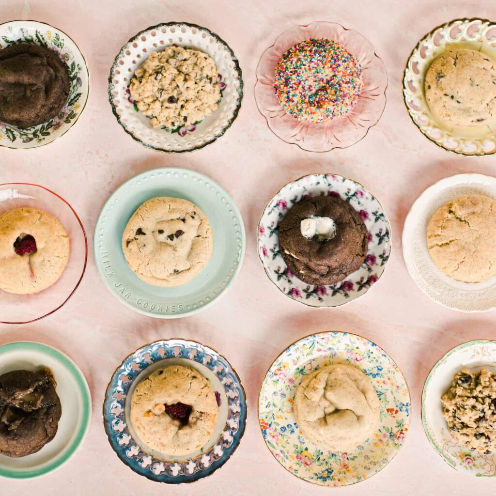 Overhead view of different cookies displayed on decorative plates