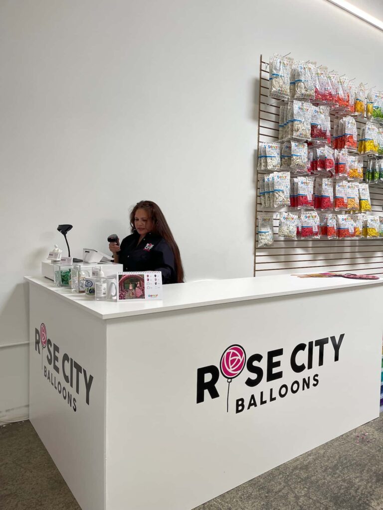 Owner of Rose City Balloons using barcode scanner with Clover Mini