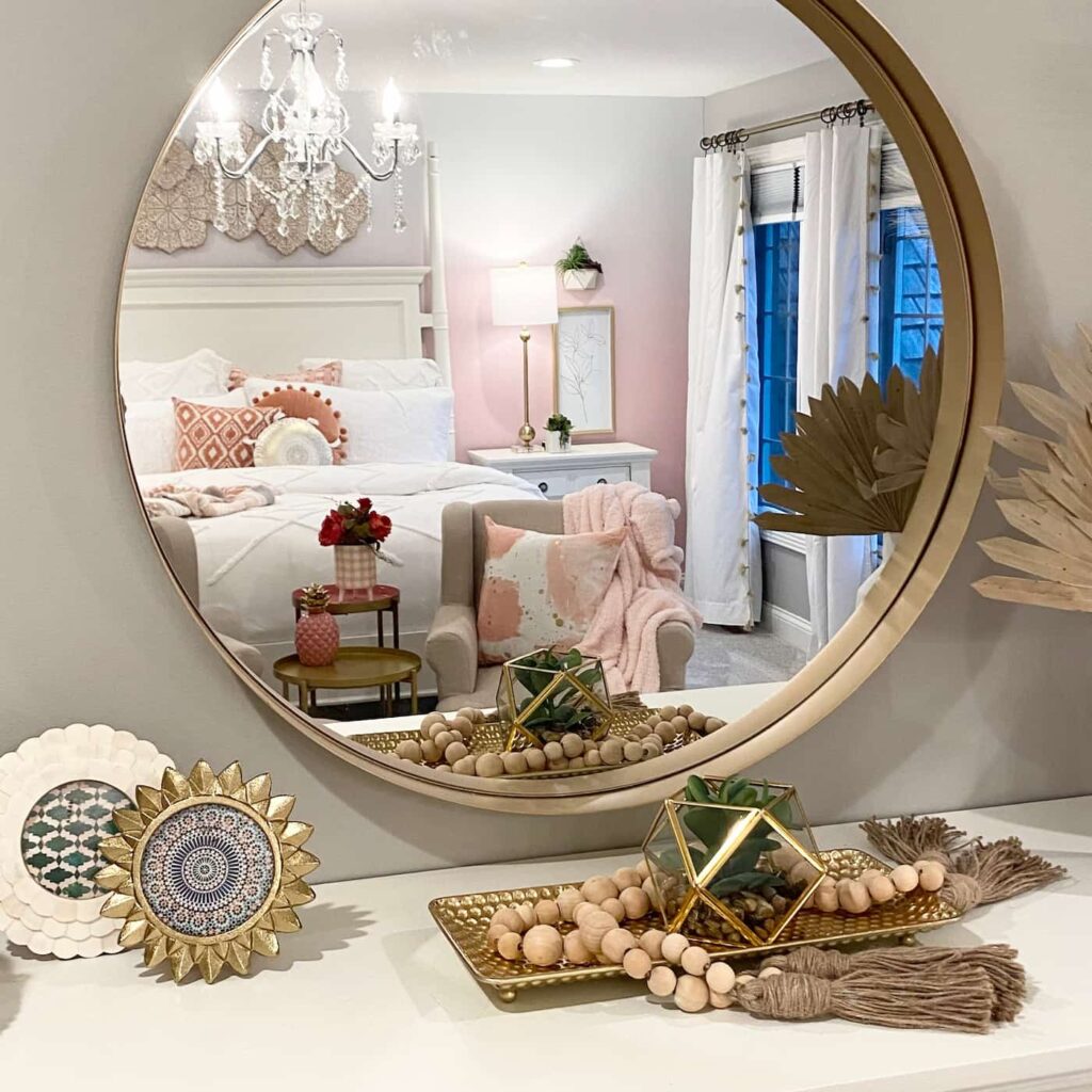 Circular mirror showing reflection of bedroom decor