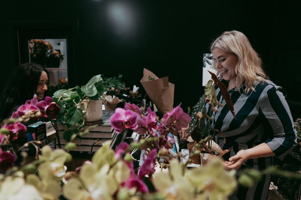 Two women working on floral arrangements