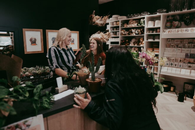 Owner of 3B's Flowers talking with others in the store