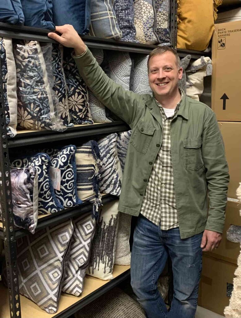 Andron Fox standing in front of shelves of pillows