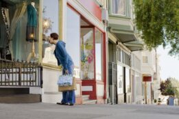Woman peering into boutique in San Francisco