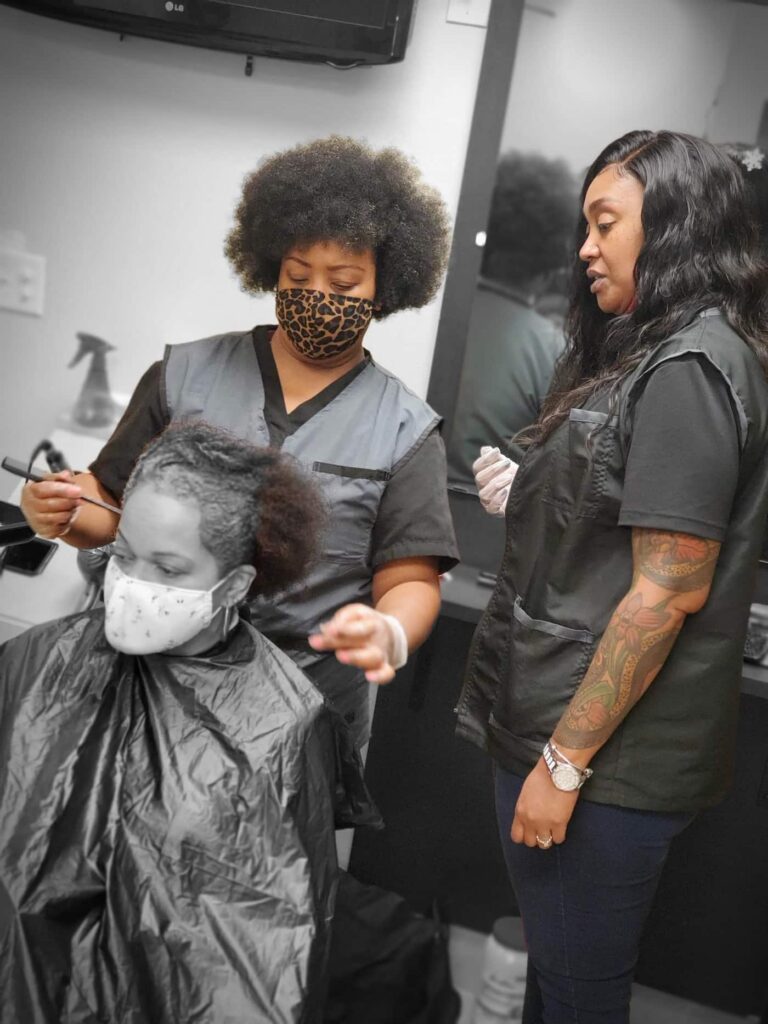 Student working on a client's hair