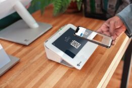 Person scanning QR code on Clover POS