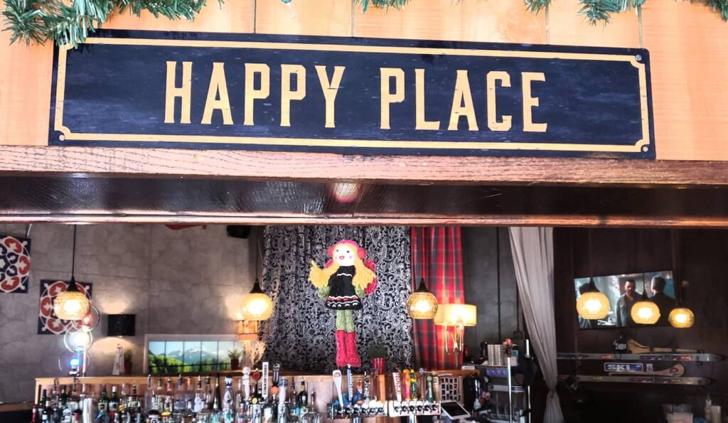 Happy Place sign above bar
