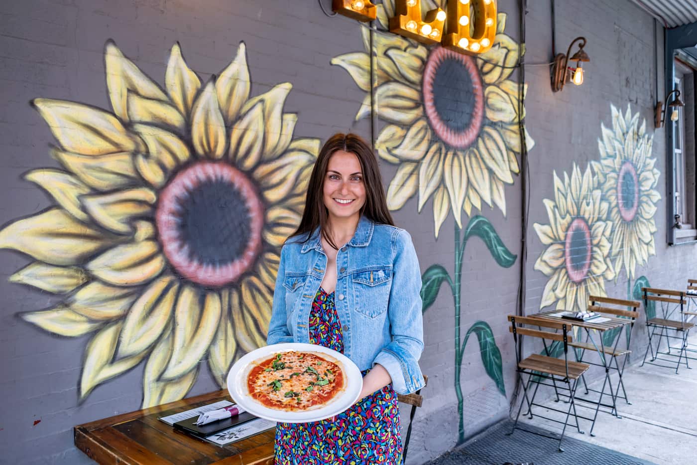 Owner of WILD Park Slope holding her famous flatbread