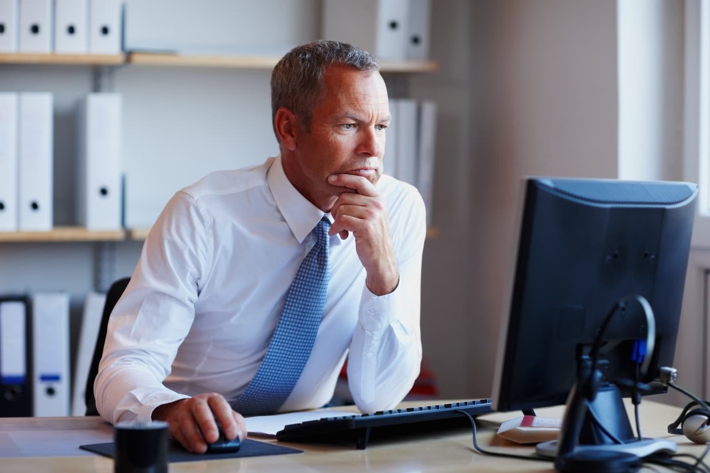 Professional man looking at a computer monitor