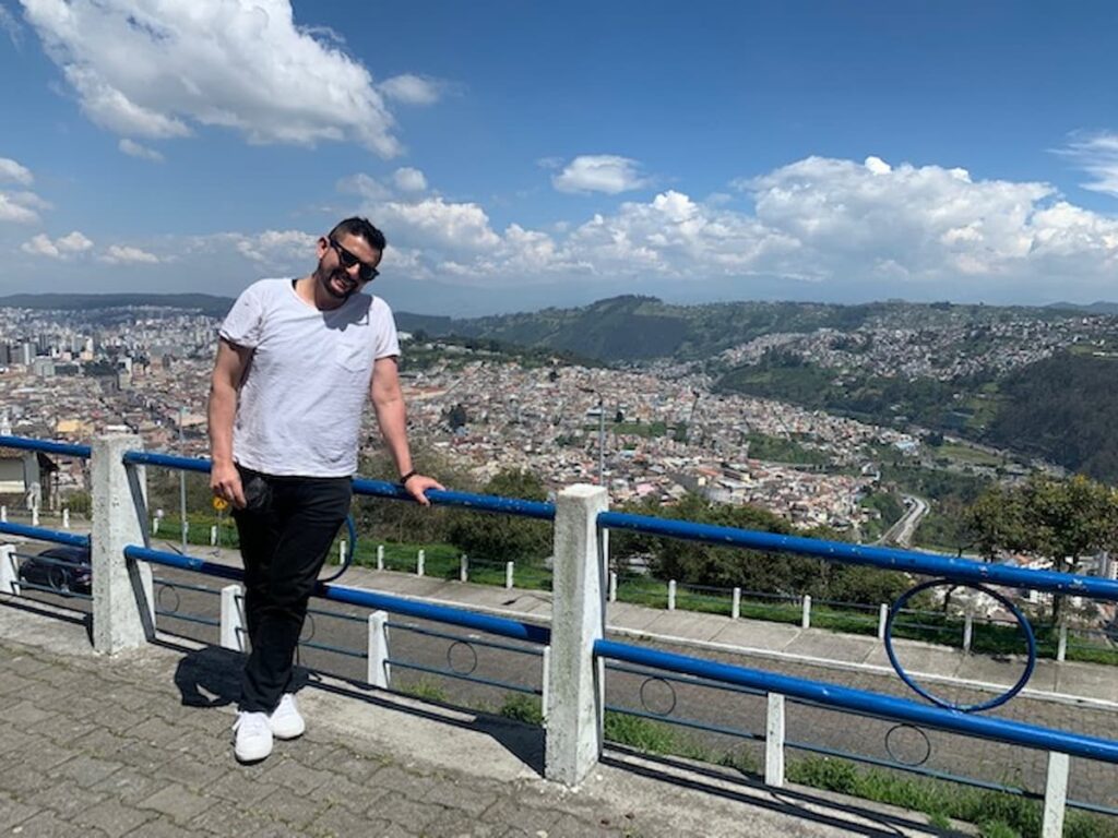 Owner of Latin Tours pictured with city on a hill in the background