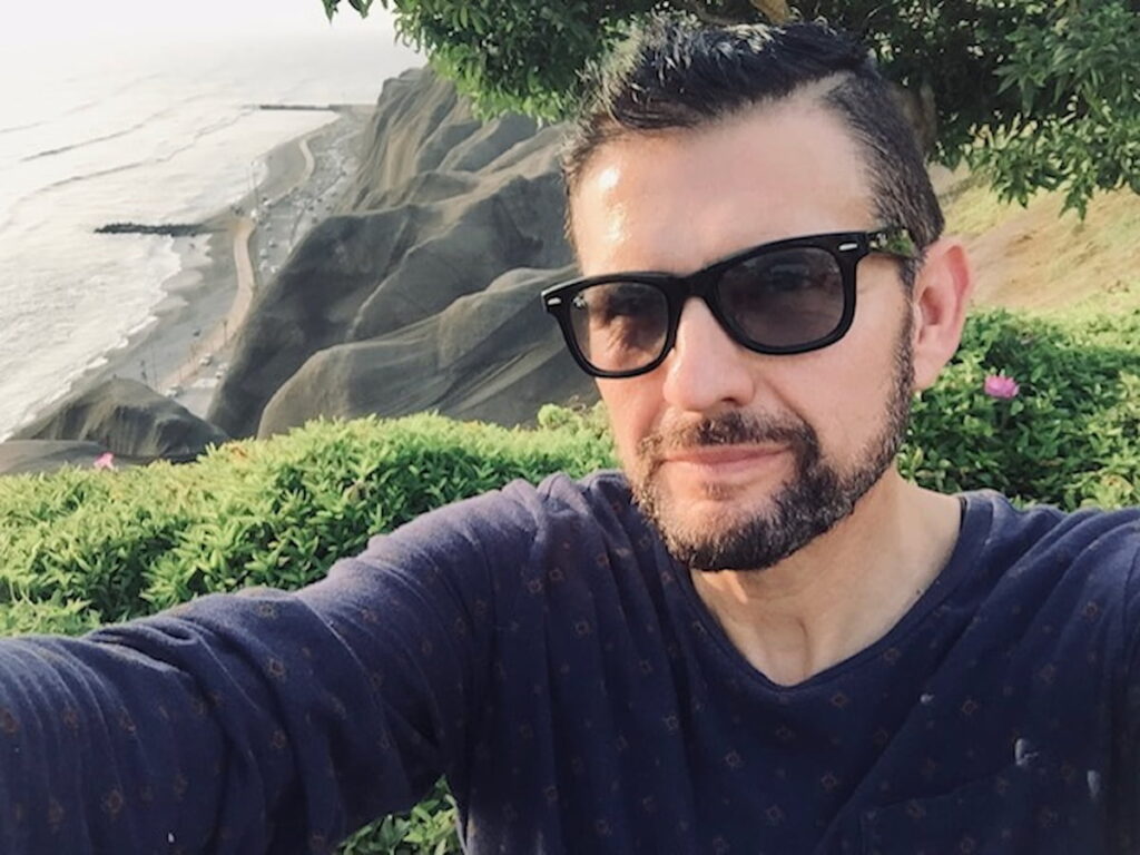 Selfie of owner of Latin Tours with coastal cliffs in the background
