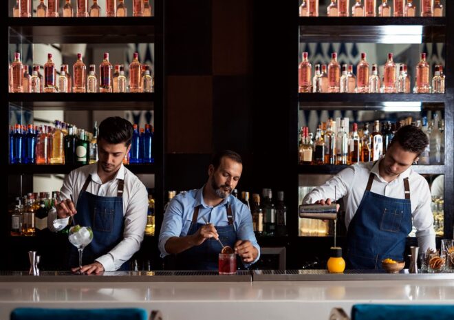 Three bartenders mixing cocktails