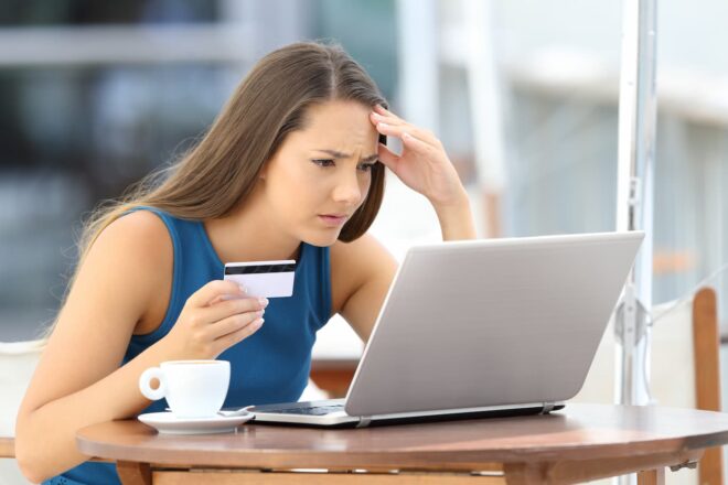Woman looking at laptop confused