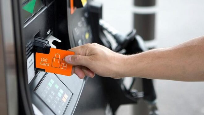 Person using gift card at gas pump