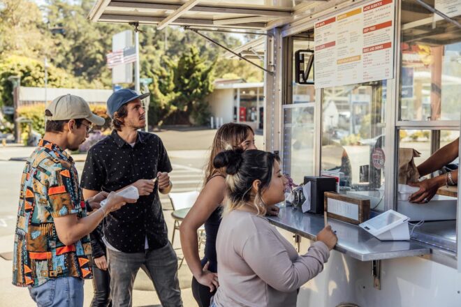 Customers placing orders outside food truck with Clover devices