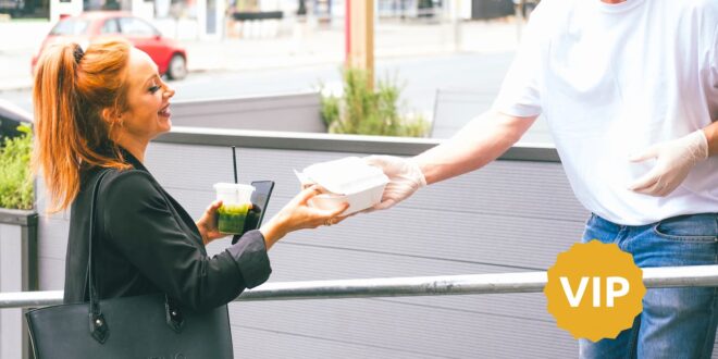 Person handing woman fast food container