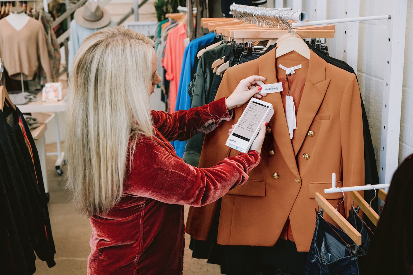 Woman scanning barcode on jacket with Clover Flex