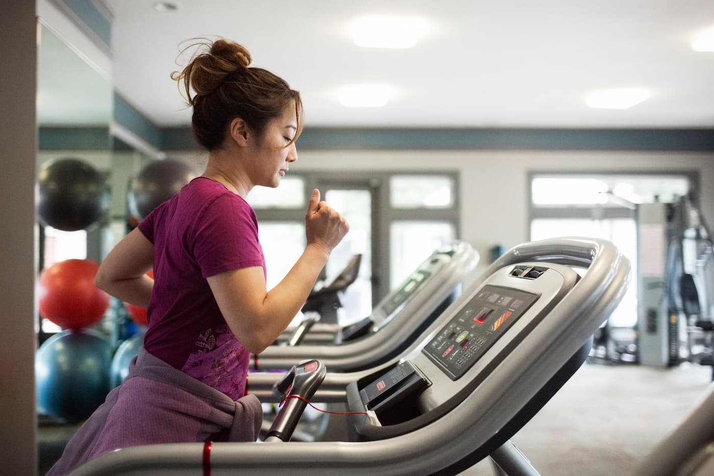 Woman walking on treadmill at gym