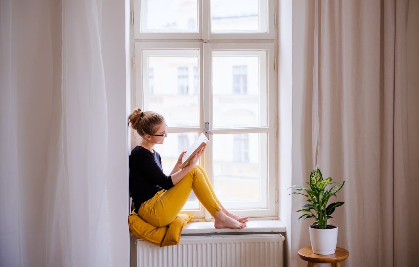 Woman reading on a window will
