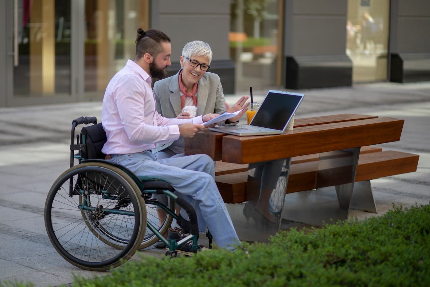 Man in wheelchair meeting with business mentor