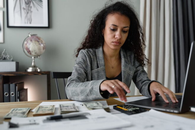 Woman in blazer working on finances