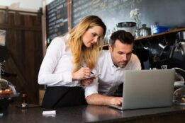 Restaurant workers looking at laptop